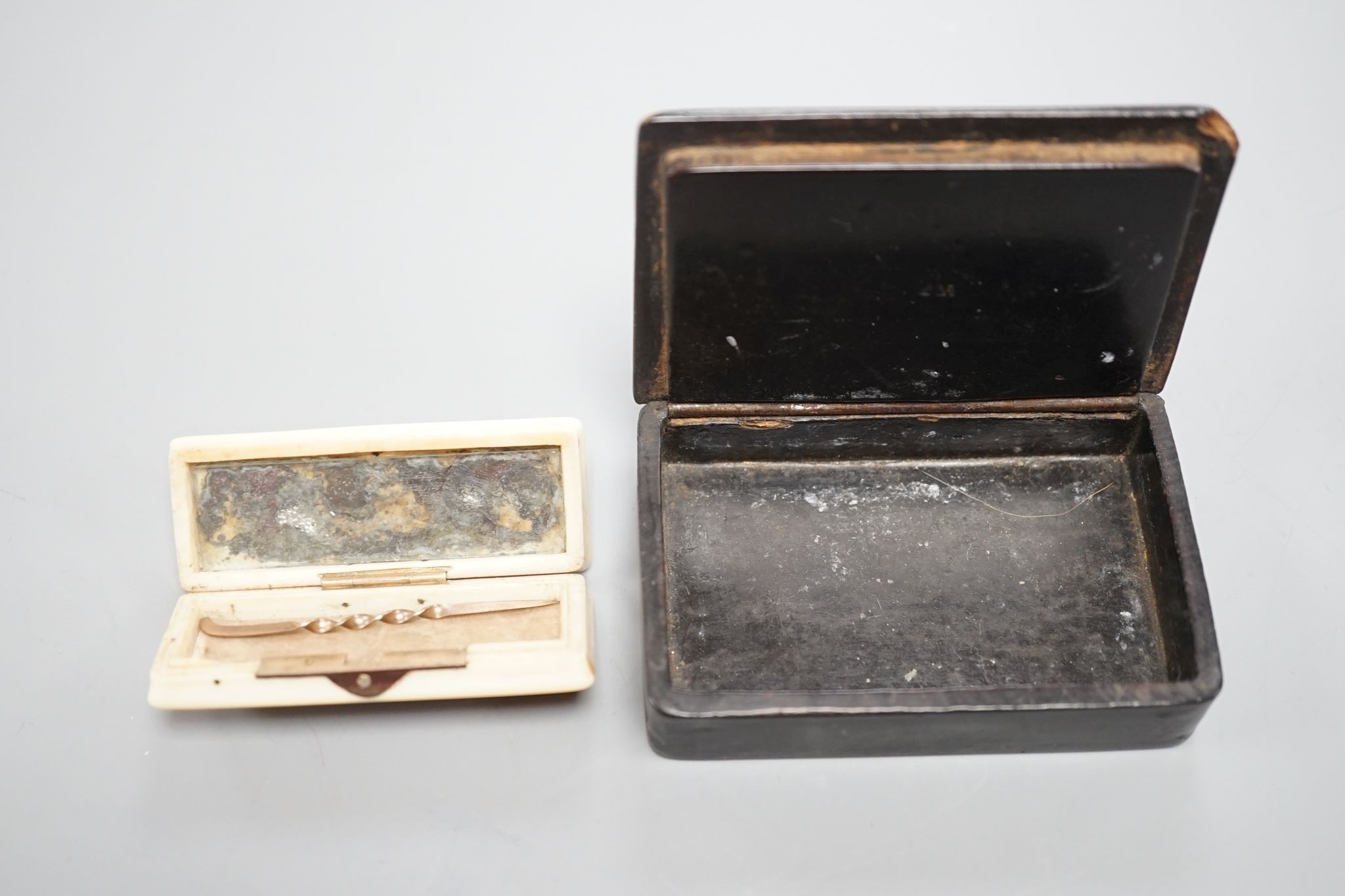 A 19th century papier mache snuff box and a similar carved ivory toothpick box, snuff box 5 cms wide x 8 cms high.